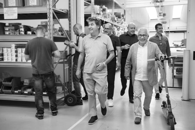 Antonio Citterio walking alongside Pietro Galimberti inside the Flexform factory