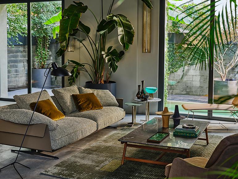 Living room of a loft with large windows and view of the pool